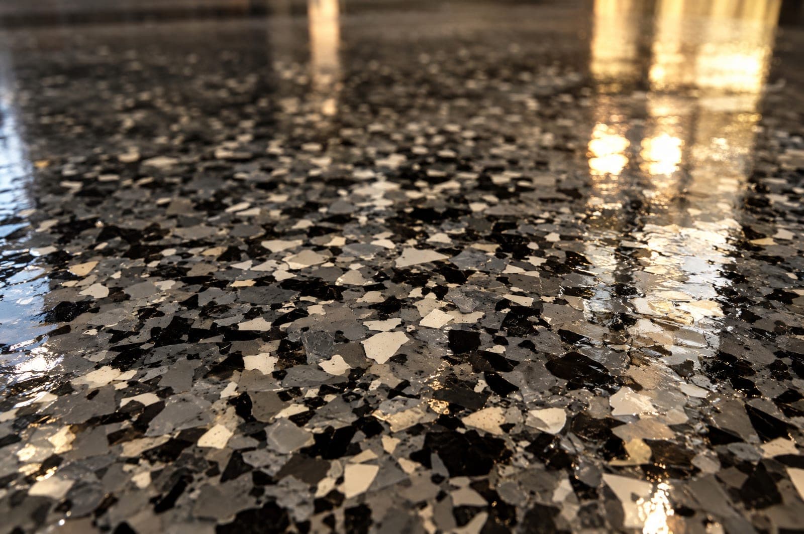 Close-up of gray, black and bone flake chips under a clear high-gloss topcoat